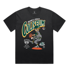 Load image into Gallery viewer, The Coliseum Tee by DOC, brought to you by Oaklandish, is a black commemorative T-shirt that showcases a graphic of a baseball player in a pitching stance, clad in green and yellow. Above the player is the text "Oakland Coliseum," and below are various logos and graphics emphasizing the team's branding and affiliations.
