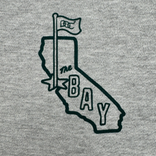 Load image into Gallery viewer, The Bay Area CC Hoodie By DOC from Oaklandish features a black outline of California with a "1850" flag and "THE BAY" text on gray heavyweight fleece in men's sizing, celebrating the San Francisco Bay Area in a simple graphic style.